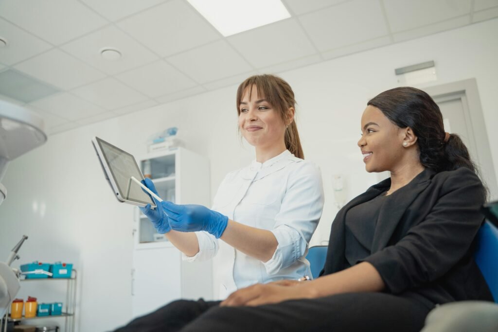 pexels photo 5355709 5355709 Dentist and patient discussing treatment plan using a tablet in a modern clinic setting.